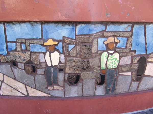 Two figures stand near automobiles on a highway.