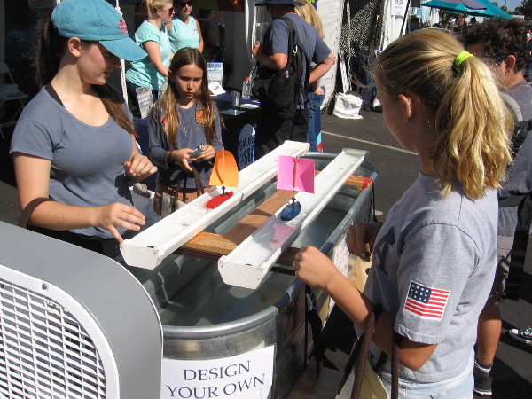 Young people compare how different sail arrangements produce speed.