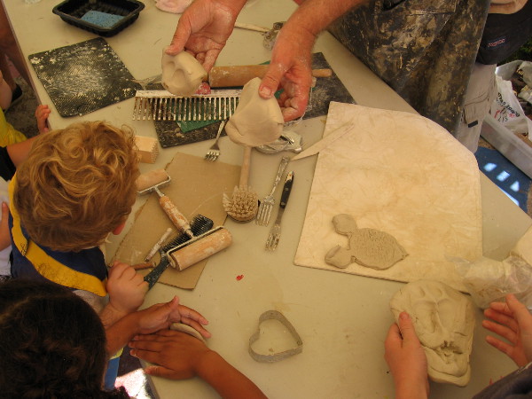 Kids learn how to sculpt in Spanish Village during Halloween Family Day.
