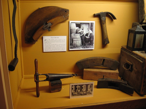 A display in the Gould Eddy Gallery shows some of the coopering tools used in making oak rum barrels.