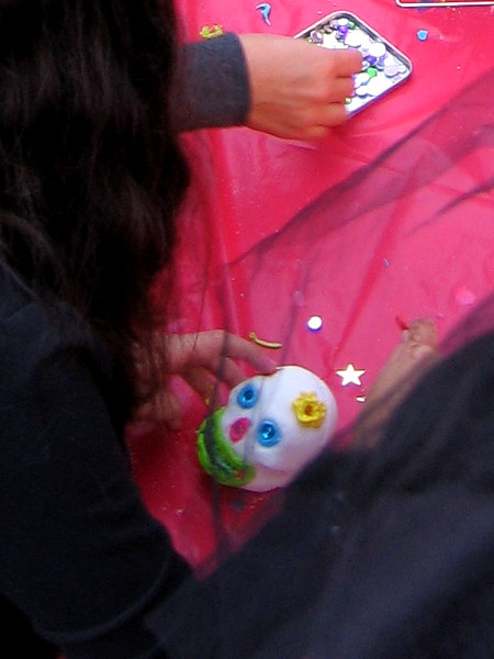 Children decorate traditional sugar skulls.