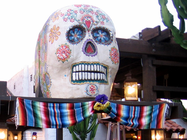 A large, colorful calavera above a restaurant inside Old Town San Diego State Historic Park.