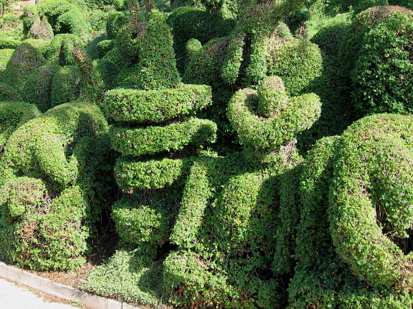 A green guy in a sombrero takes a siesta. Perhaps this is his dream.
