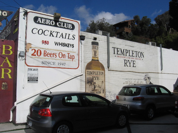 Bold graphics on the white wall by their parking lot.