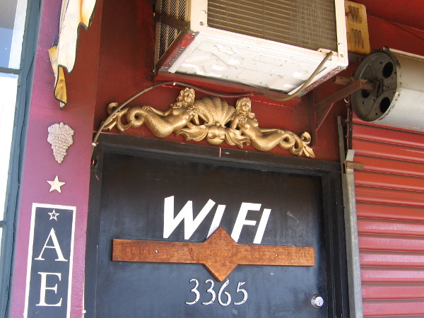 Two golden mermaids above the front door of the Aero Club.
