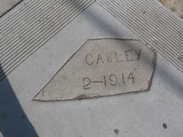 A fragment of sidewalk remains from 1914.