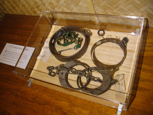 Slave collars from the 18th century. Some believe African slaves in the Caribbean discovered the process of distilling the residue of sugar refining--molasses and sugarcane juice--into alcohol.