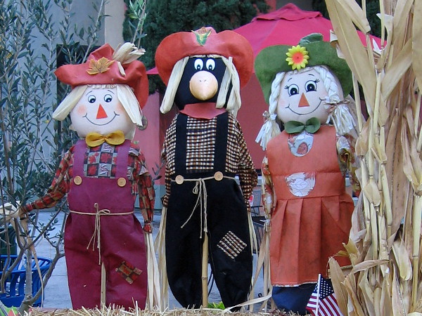 That scarecrow in the middle looks like a crow in disguise!