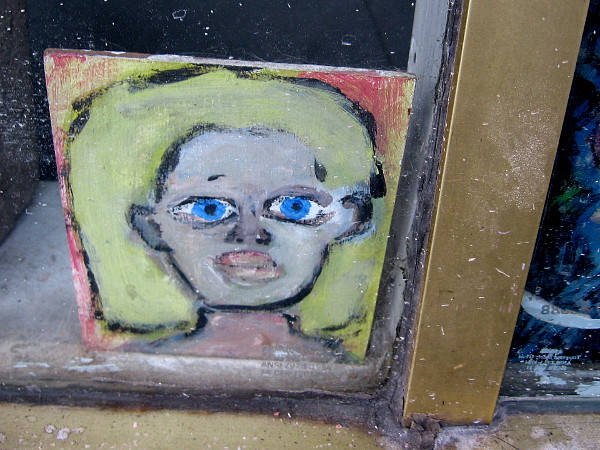 Someone is wide awake and bright-eyed behind this shop window.