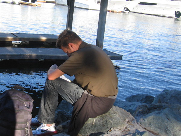 Reading words by the tranquil water. Sensing deeper truths.