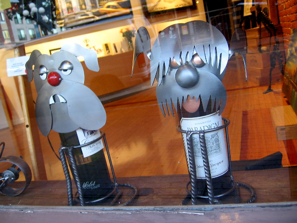 These two dogs in the Michael J. Wolf Fine Arts gallery must like to wine.