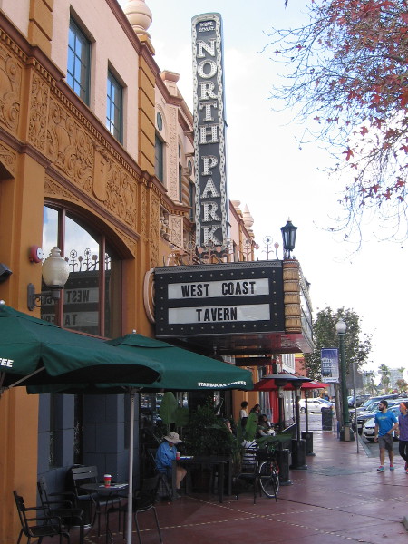 Diners sit outside the West Coast Tavern in North Park. The building is a former movie theater.