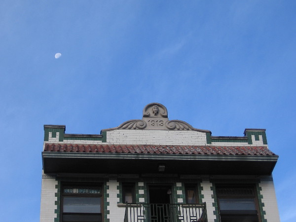 The moon in the sky above a historic building in the Gaslamp Quarter.