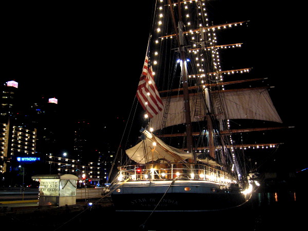 Photo of Maritime Museum of San Diego's famous Star of India, with magical holiday lights strung along masts, yards and rigging.