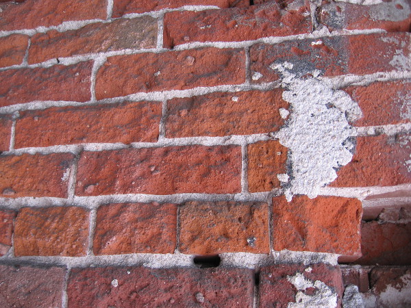 Old bricks of a Gaslamp building have been patched.