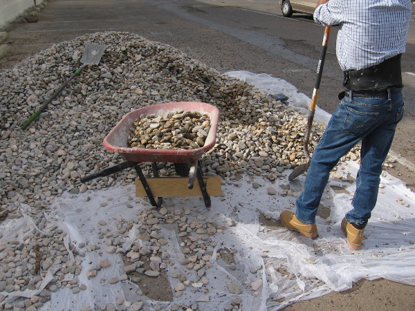 Shoveling weathered stones. Wheeling them about.