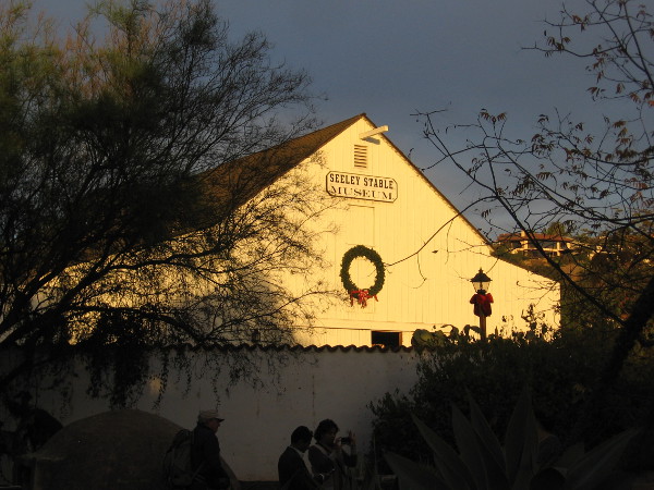 A big wreath adds holiday cheer to the sunlit Seeley Stable Museum barn.