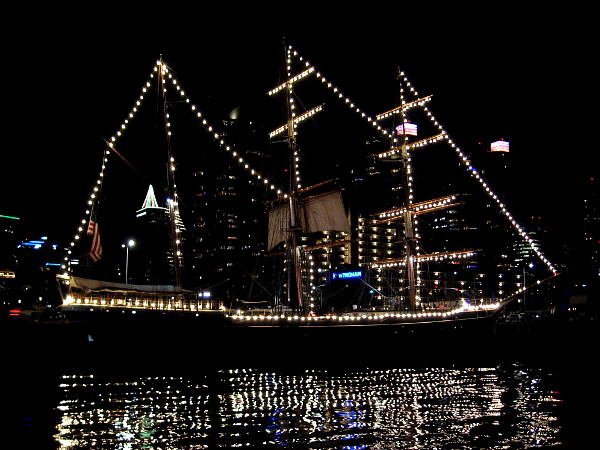 The reflection of downtown windows and Star of India's holiday lights creates a fantastic sight after nightfall on San Diego Bay.