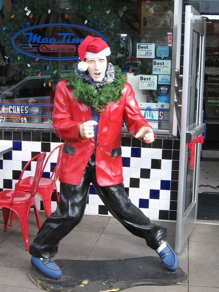 Santa Elvis at MooTime Creamery is sporting a wreath around his neck.