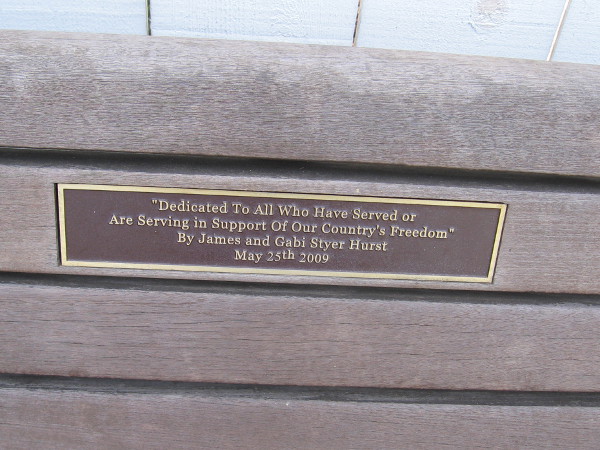 Plaque on bench reads Dedicated to All Who Have Served or Are Serving in Support of Our Country's Freedom.