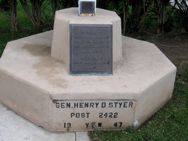 Plaque at base of flagpole reads In Honor of the Coronado Men and Women Who Served in the Armed Forces in World War II.