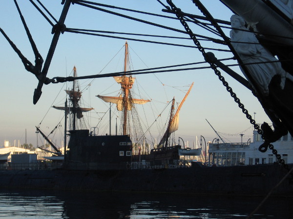 Masts and furled sails of the Spanish galleon replica San Salvador turn golden a few minutes after sunrise.
