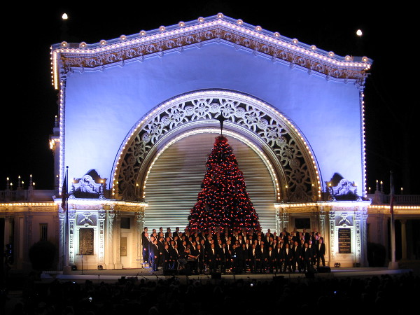 A choir performs holiday songs for a large December Nights crowd.