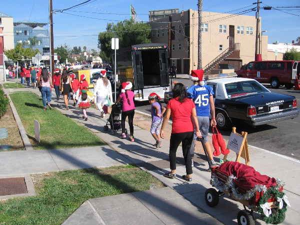 Kids head toward the parade route, which begins along University Avenue in San Diego's North Park neighborhood.