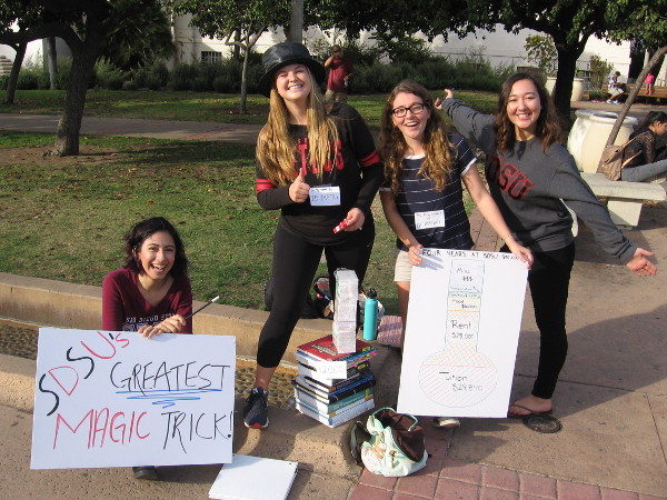 Friendly SDSU students perform a magic trick in Balboa Park. They demonstrate how high tuitions make money disappear!