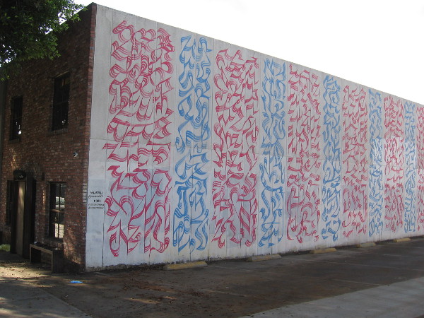 Abstract calligraphy panels on a wall facing E Street near 11th Avenue, created by Brazilian multimedia artist Yomar Augusto for Design Forward San Diego.