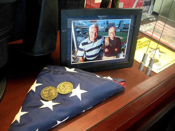Inside a lounge area for the press is a glass display case full of memories from Jerry Coleman's life as baseball player, Marine aviator, and Padres broadcaster. The flag was presented to him upon his retirement by the military.