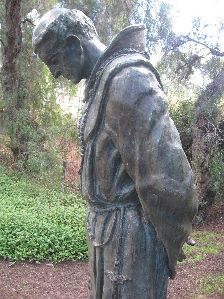 The Padre seems to be lost in prayer or silent contemplation.