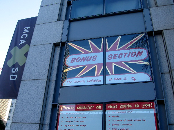 A splash of words, asking passersby what the ultimate definition of race is.