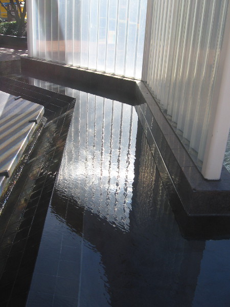 Light reflecting from and passing through the prism wall reflects from a basin of water.