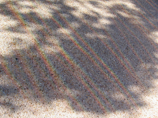 The colors of the visible spectrum appear like linear rainbows at one's feet near this surprising sculpture.