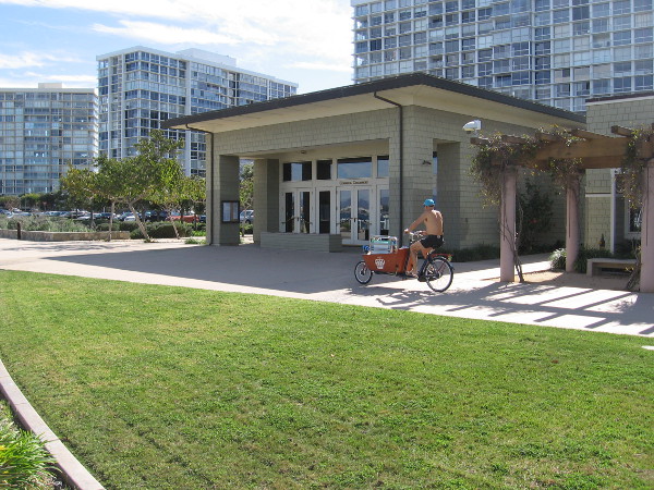 Bicyclist rides past City of Coronado City Hall, next to San Diego Bay.