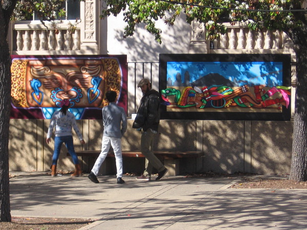 Visitors to Balboa Park check out a couple of the murals temporarily on display in the Plaza de Panama.