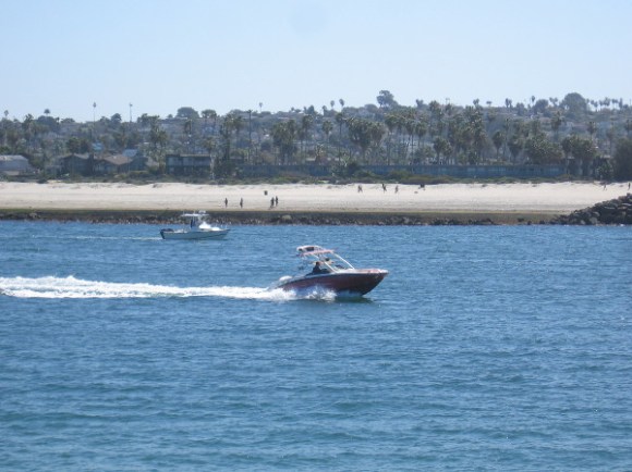 Point Loma rises beyond a second jetty that separates the entrance channel from the San Diego River.