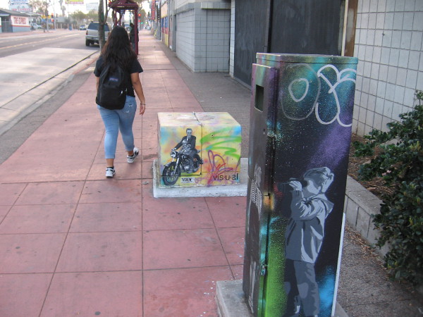 Walking east down University Avenue I spied more street art on electrical boxes.