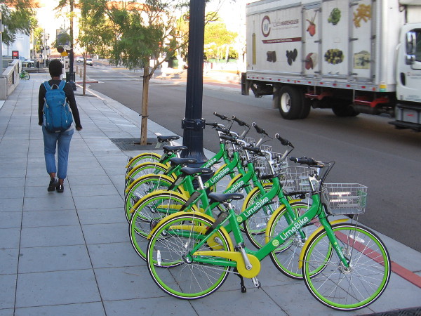 Rows of bright new LimeBike smart bicycles have appeared in downtown San Diego.
