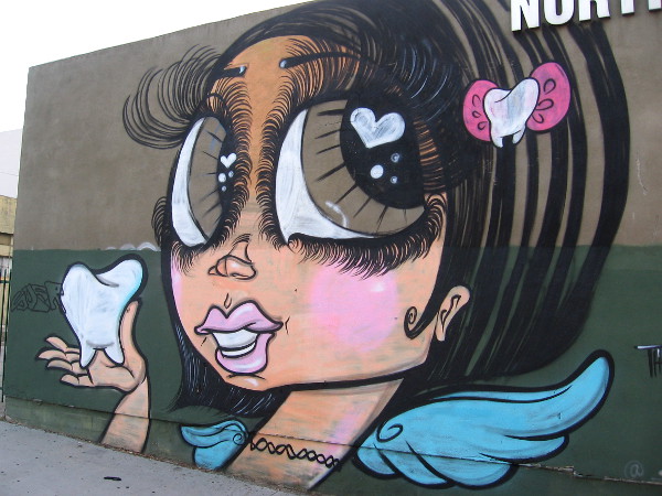 It's the Tooth Fairy on the side of North Park Dental! By artist Sand One, a Latina street artist from East Los Angeles.