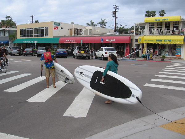 Carrying paddleboards west toward the nearby beach. Kayaking in the Pacific Ocean off La Jolla is also very popular.