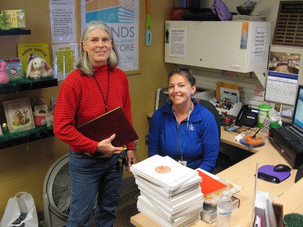Two super nice volunteers pose for a pic inside the cool Friends of the Central Library Bookstore!