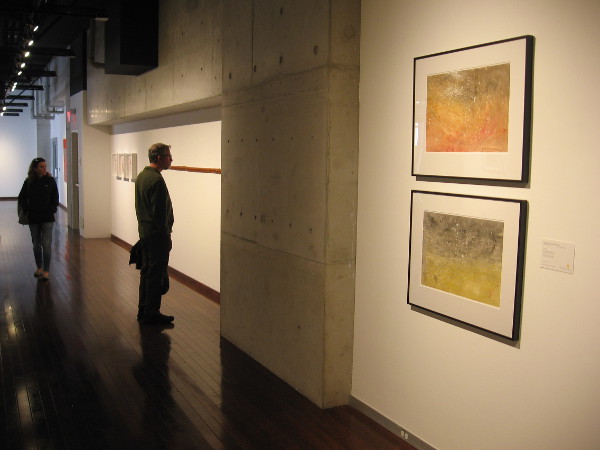 Visitors to the gallery on the 9th floor of the downtown San Diego Central Library look at some fascinating artwork.