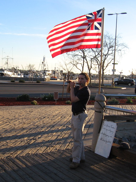 Playing the fife beneath the Grand Union Flag near the Greatest Generation Walk.