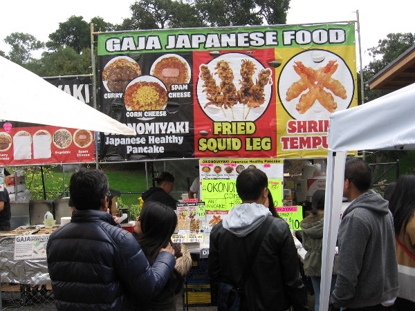 Checking out a big selection of Japanese food, including fried squid leg and shrimp tempura.