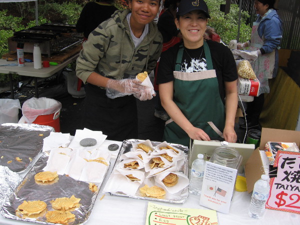 These guys hold up a sweet fish-shaped taiyaki. Yum! I had one last year, too!