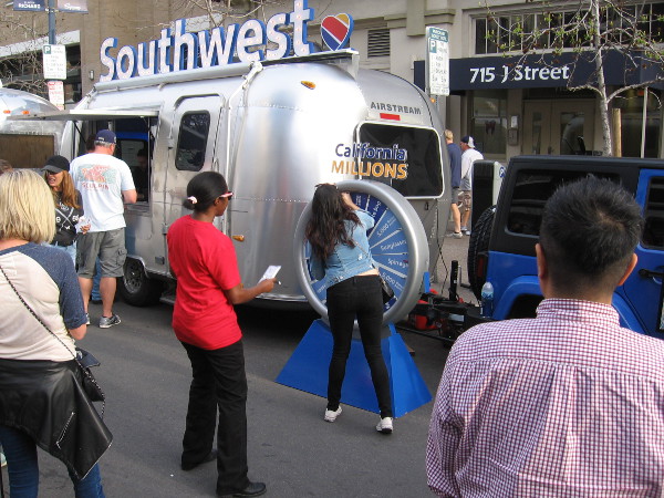 Lots of people were lined up to spin a California Millions prize wheel.