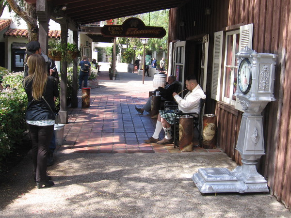 Man in kilt, smoking a pipe, relaxes in Seaport Village on St. Patrick's Day.