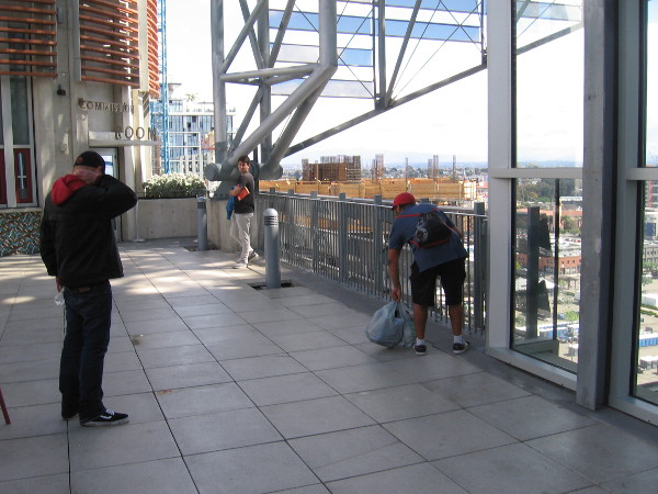 People linger high above the city on the 9th floor of the Central Library.